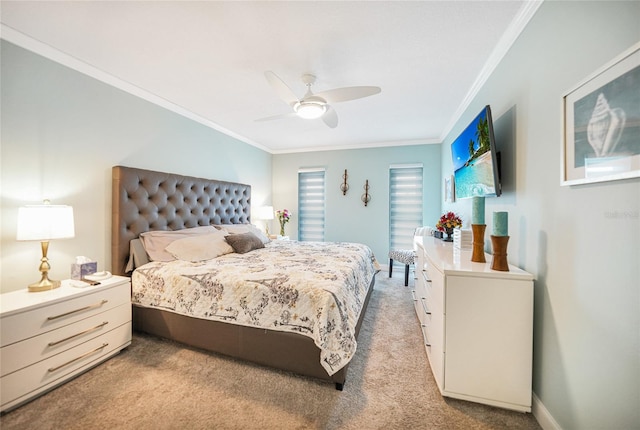 carpeted bedroom featuring ceiling fan and crown molding