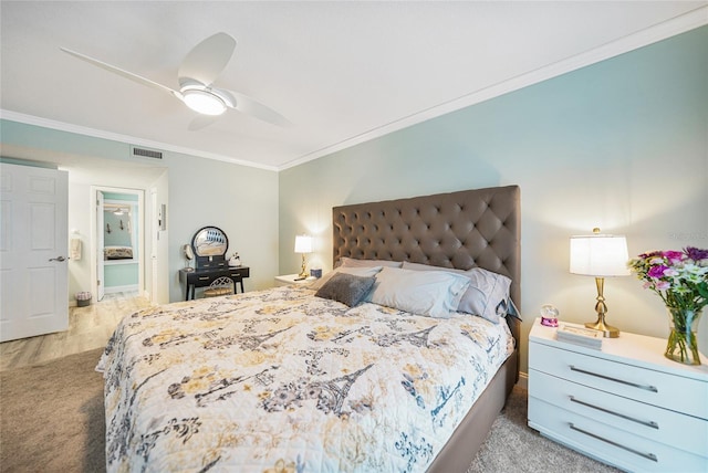 bedroom featuring ceiling fan, light colored carpet, and crown molding