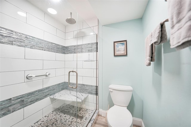 bathroom featuring toilet and walk in shower