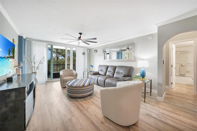 living room with crown molding, light hardwood / wood-style flooring, ceiling fan, and a textured ceiling