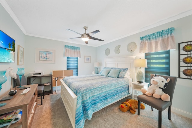 carpeted bedroom featuring ceiling fan and crown molding