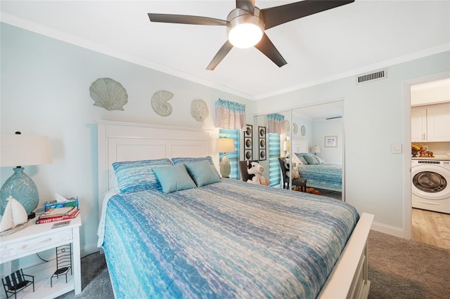 bedroom with washer / clothes dryer, ceiling fan, a closet, and ornamental molding