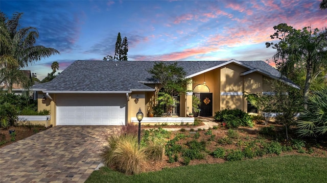 ranch-style home featuring a garage