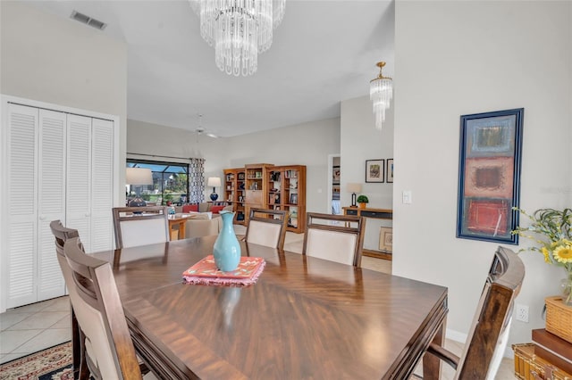 dining area featuring light tile patterned floors and ceiling fan with notable chandelier