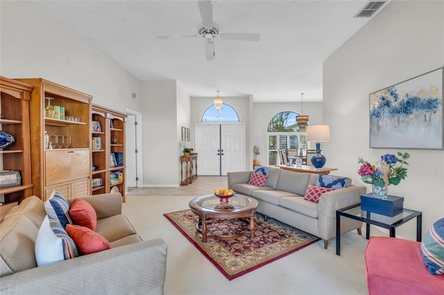 carpeted living room with ceiling fan