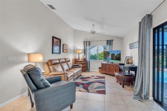 living room with ceiling fan, lofted ceiling, and light tile patterned floors