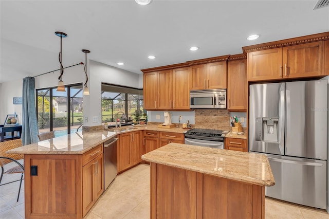 kitchen with light stone countertops, stainless steel appliances, light tile patterned floors, pendant lighting, and a kitchen island