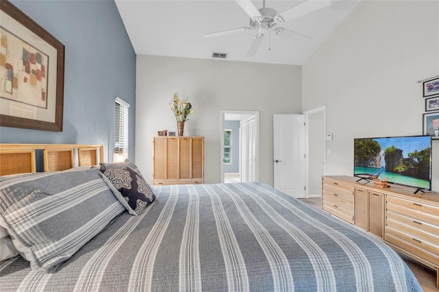 carpeted bedroom featuring multiple windows, high vaulted ceiling, and ceiling fan