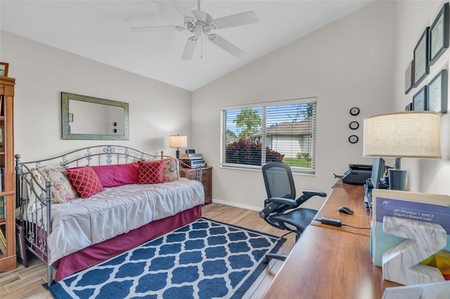 office space featuring ceiling fan, lofted ceiling, and light hardwood / wood-style flooring