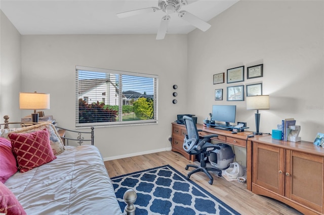 home office with light wood-type flooring, high vaulted ceiling, and ceiling fan