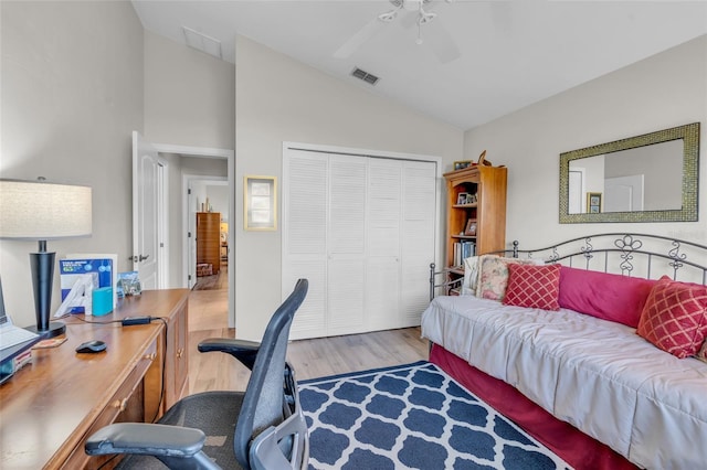 home office with light hardwood / wood-style floors, ceiling fan, and lofted ceiling