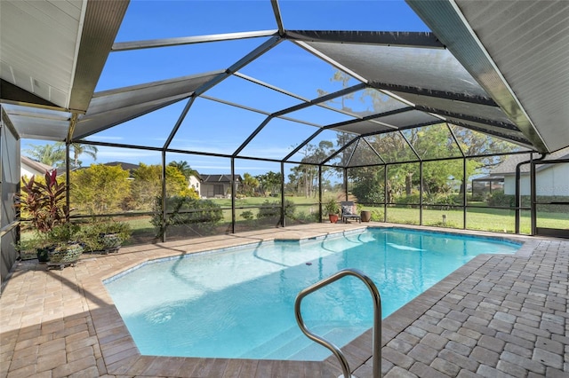 view of swimming pool featuring a patio area, a lanai, and a yard