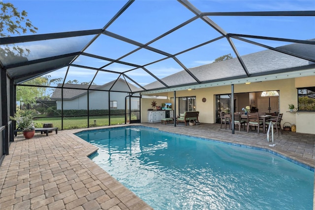 view of swimming pool with a patio area and a lanai