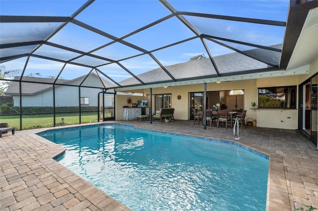 view of swimming pool with a patio area and a lanai