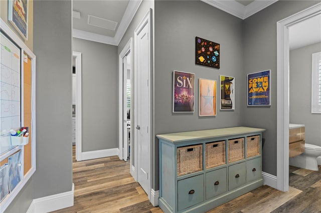 hallway with dark hardwood / wood-style flooring and ornamental molding