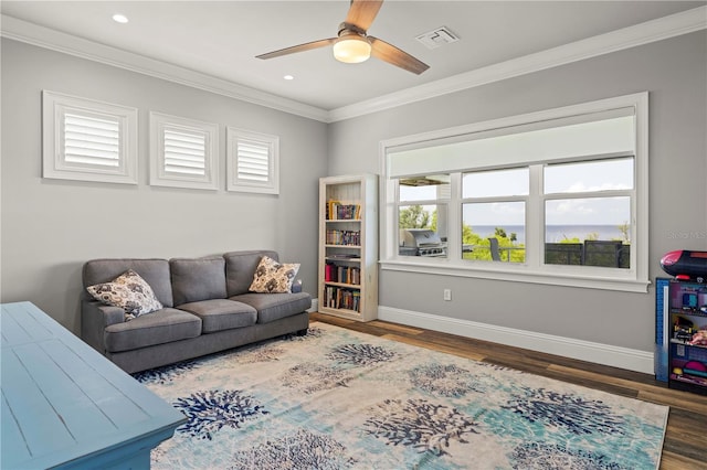 living room featuring ceiling fan, wood-type flooring, and crown molding