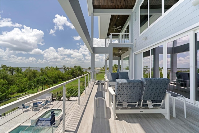 wooden deck with outdoor lounge area, ceiling fan, and a pool with hot tub