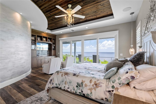 bedroom with dark hardwood / wood-style floors, ceiling fan, access to exterior, a tray ceiling, and wood ceiling