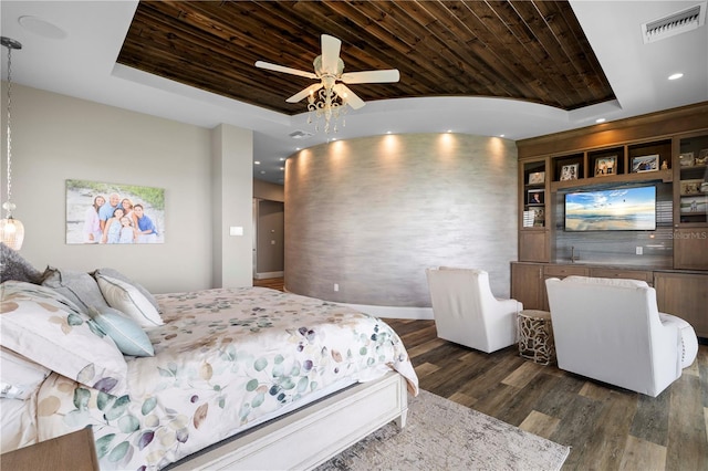 bedroom featuring a tray ceiling, ceiling fan, dark hardwood / wood-style flooring, and wood ceiling