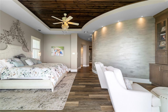 bedroom featuring a tray ceiling, ceiling fan, wood ceiling, and dark hardwood / wood-style floors