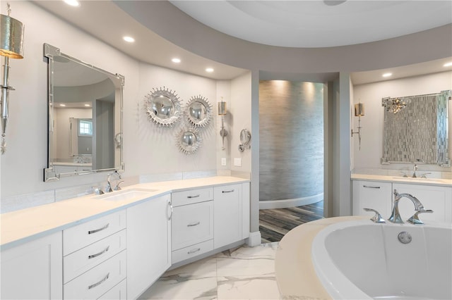 bathroom featuring a bathing tub, vanity, and hardwood / wood-style floors