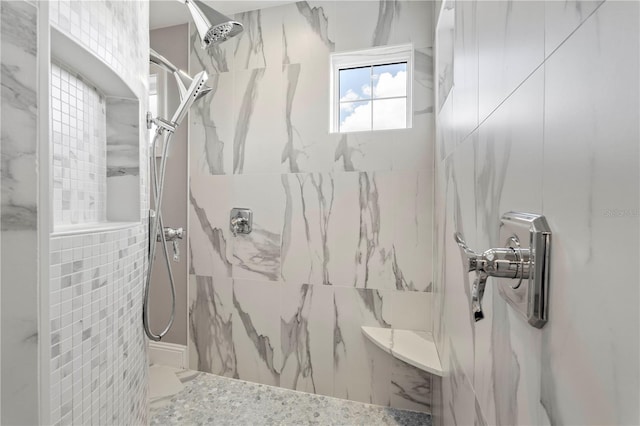 bathroom with a tile shower and tile walls