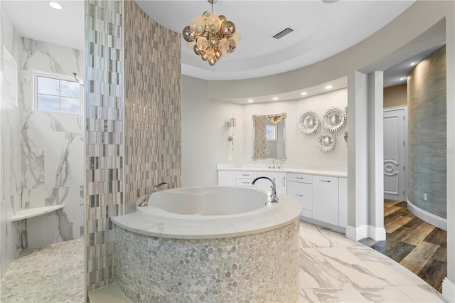 bathroom featuring separate shower and tub, vanity, wood-type flooring, and a notable chandelier