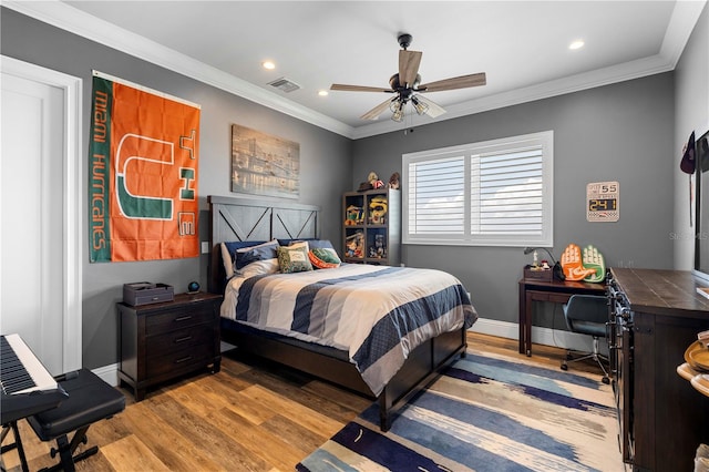 bedroom with light wood-type flooring, ceiling fan, and crown molding