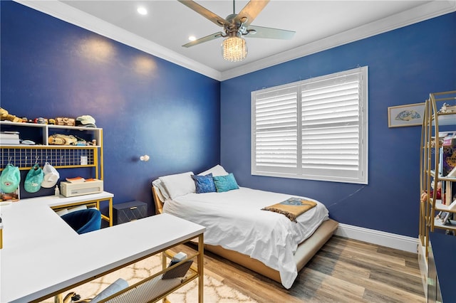 bedroom with hardwood / wood-style floors, ceiling fan, and crown molding