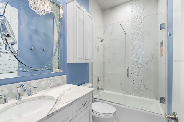 full bathroom with shower / bath combination with glass door, vanity, and toilet