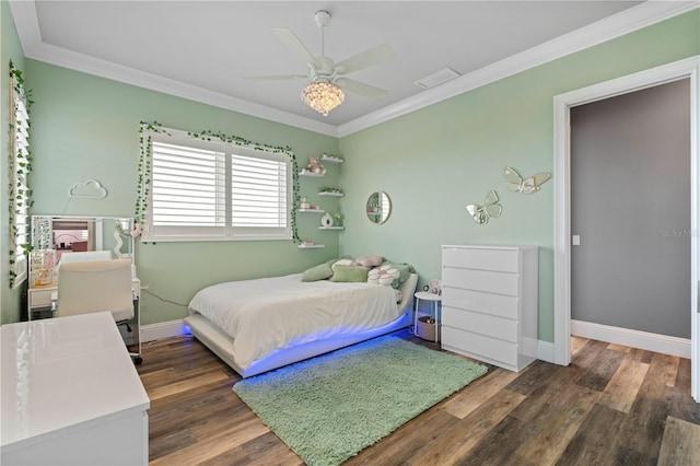 bedroom with ceiling fan, dark hardwood / wood-style flooring, and ornamental molding