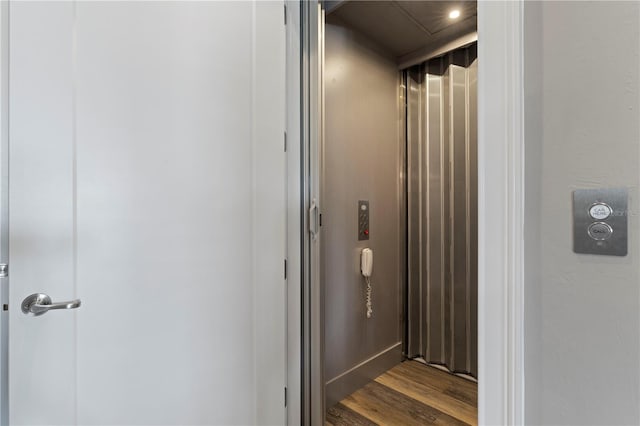 bathroom featuring hardwood / wood-style floors and elevator