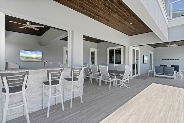 wooden terrace with ceiling fan and an outdoor bar