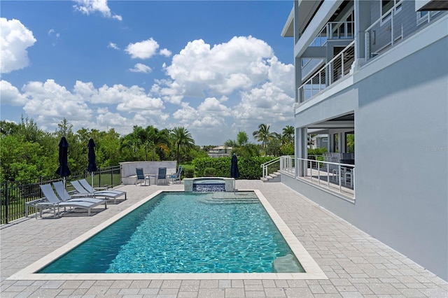 view of swimming pool featuring an in ground hot tub and a patio