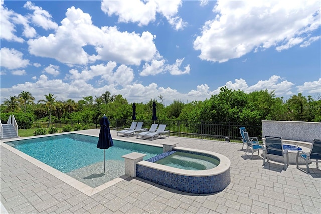 view of swimming pool with an in ground hot tub and a patio area