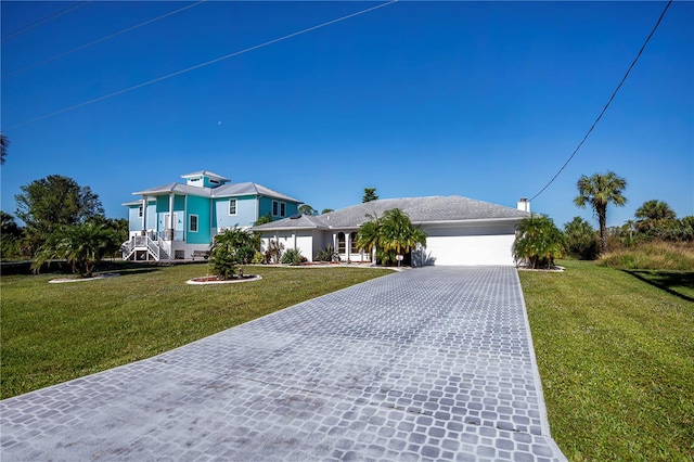 view of front of property featuring a garage and a front lawn