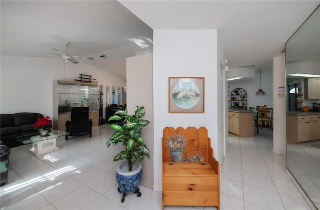 interior space featuring light tile patterned floors and vaulted ceiling