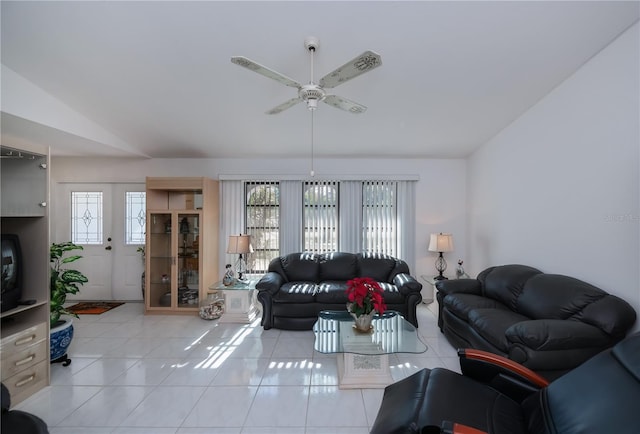 tiled living room featuring a wealth of natural light, ceiling fan, and vaulted ceiling