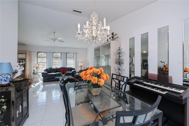 dining area featuring light tile patterned floors and ceiling fan with notable chandelier