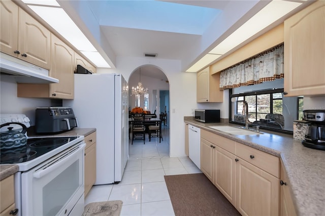 kitchen featuring white appliances, sink, pendant lighting, a chandelier, and light tile patterned flooring