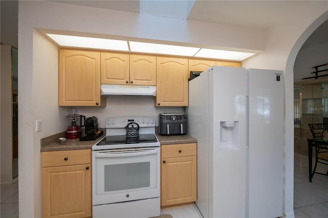 kitchen featuring light brown cabinets, white appliances, and light tile patterned floors