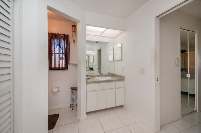 bathroom featuring tile patterned flooring and vanity