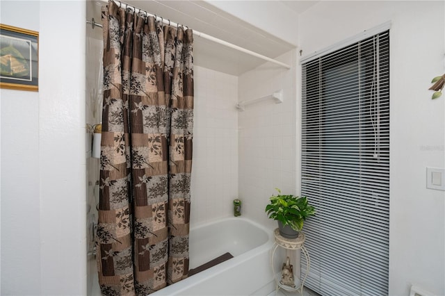 bathroom with shower / bath combination with curtain