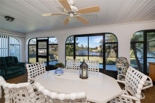 sunroom with ceiling fan and wooden ceiling