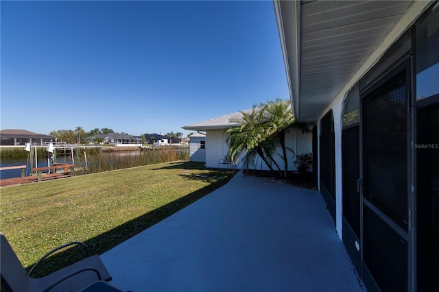 view of yard featuring a water view and a patio area