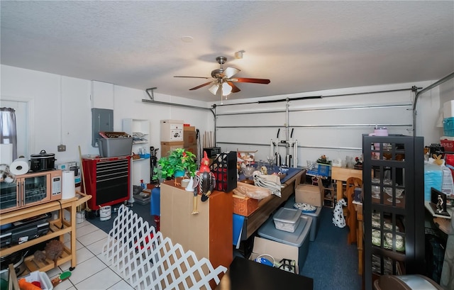 garage with electric panel and ceiling fan