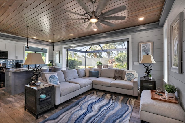 living room with wooden walls, dark hardwood / wood-style flooring, ceiling fan, and wooden ceiling