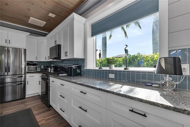 kitchen with white cabinetry, dark wood-type flooring, backsplash, dark stone counters, and black appliances