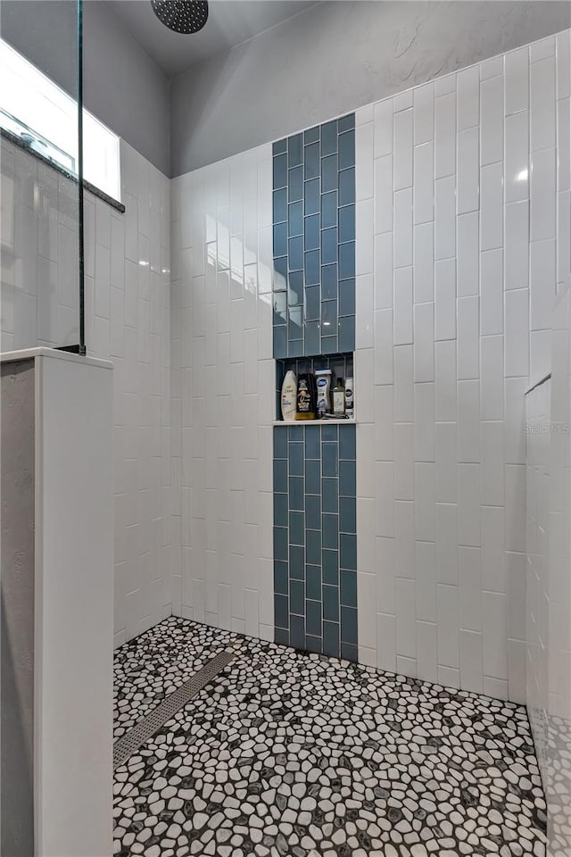 bathroom with a tile shower