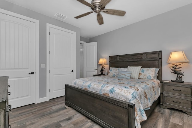 bedroom featuring ceiling fan and dark hardwood / wood-style floors